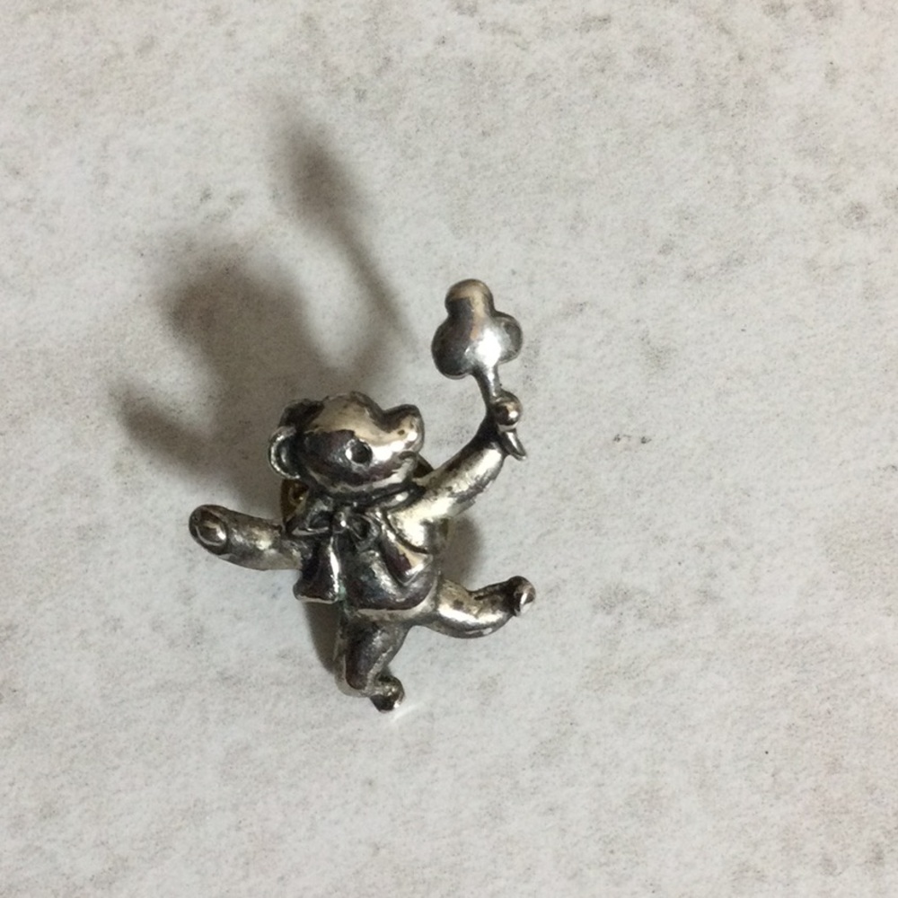 Pewter teddy bear holding shamrock pin